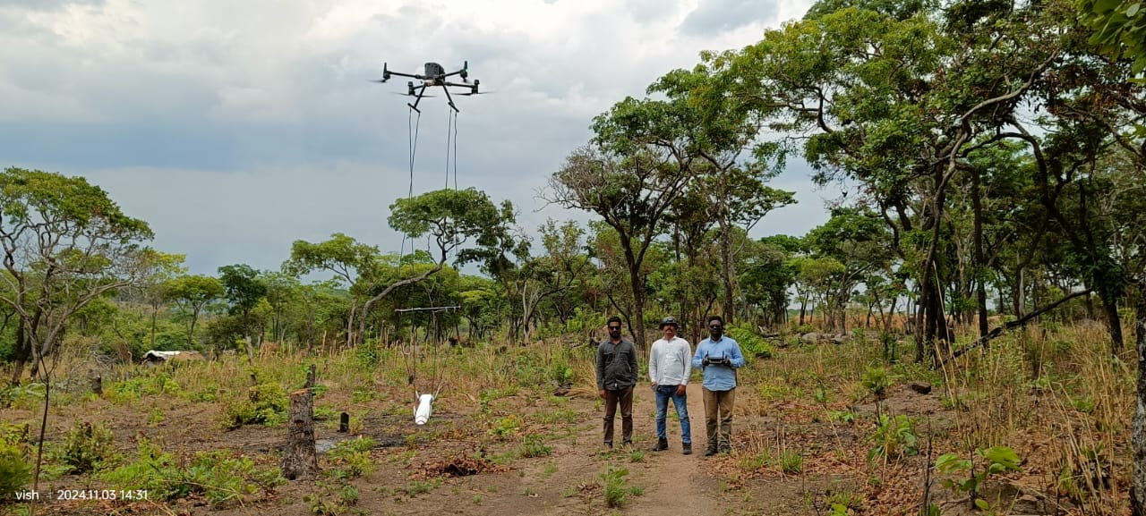 Drone-borne magnetometer flying a systematic survey line over forested terrain