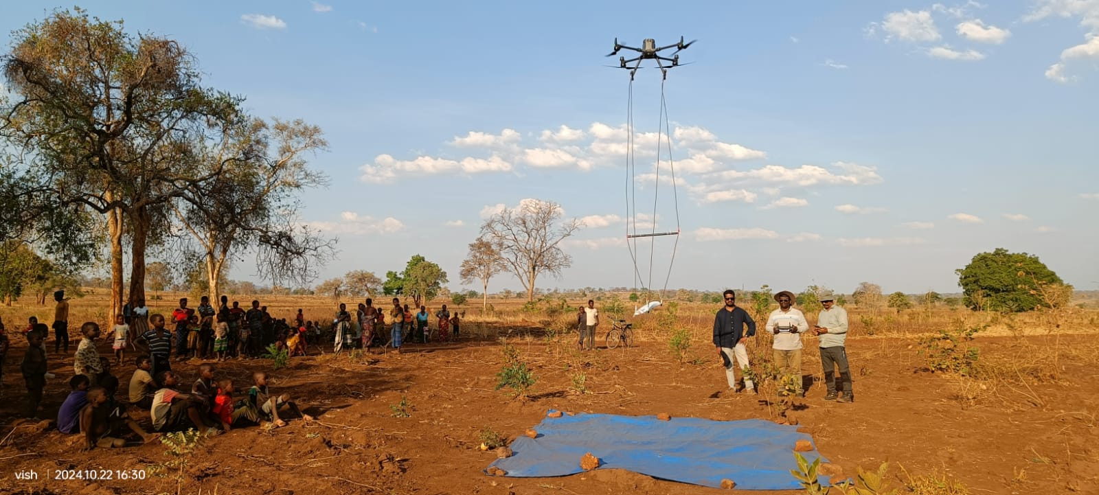 Survey drone lifting a magnetometer sensor loop over an open field