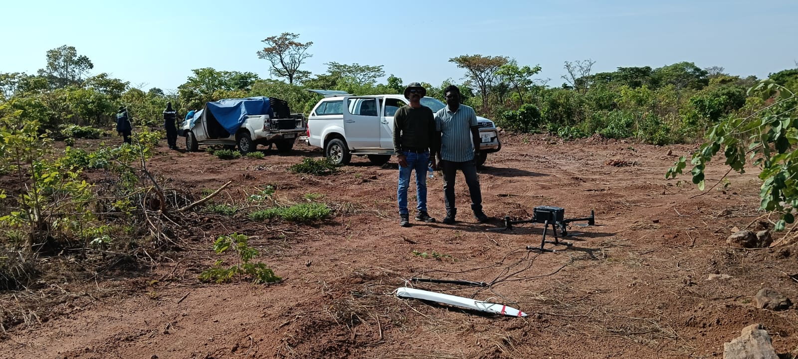 Arkman Dynamics survey crew with vehicles and equipment at a field site