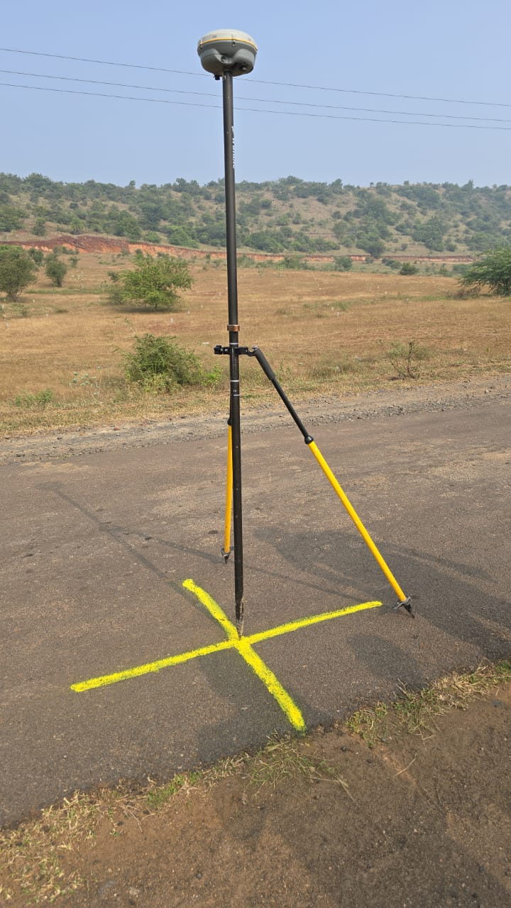 GNSS receiver set over a control point marked on a road surface